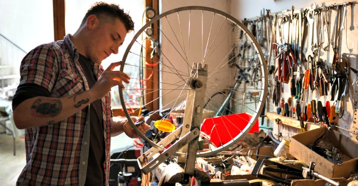 man fixing bicycle